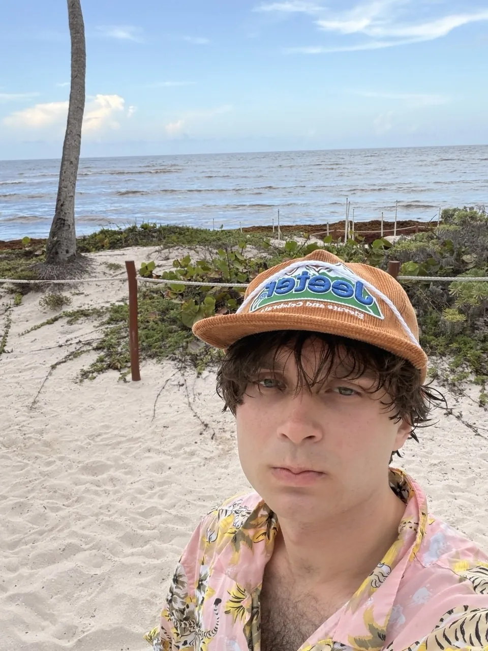 Artem Sumin at the beach in a bucket hat