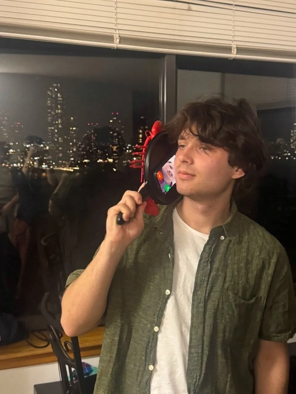 Artem Sumin at night with the city skyline behind him