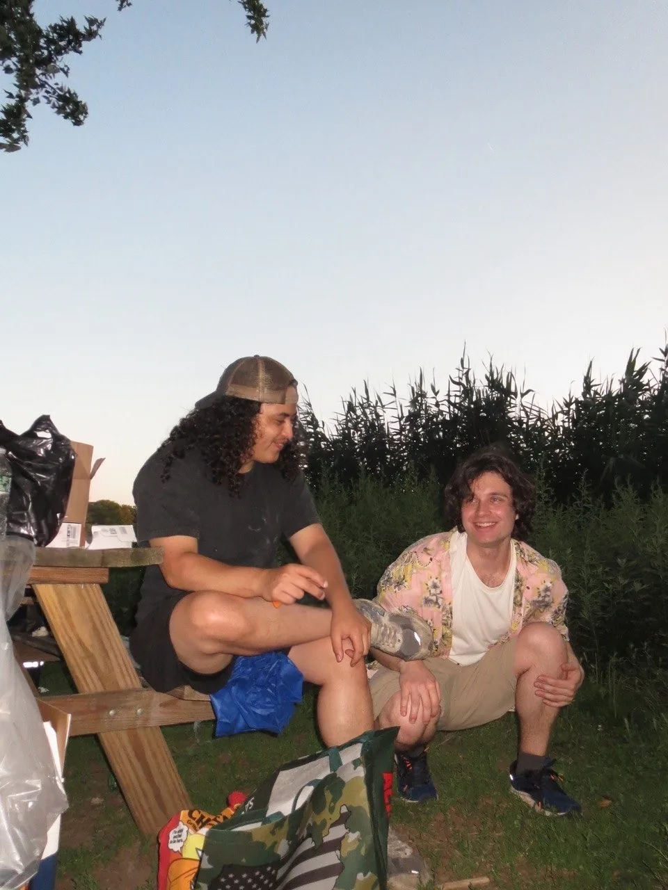 Artem Sumin and a friend at a picnic table outdoors
